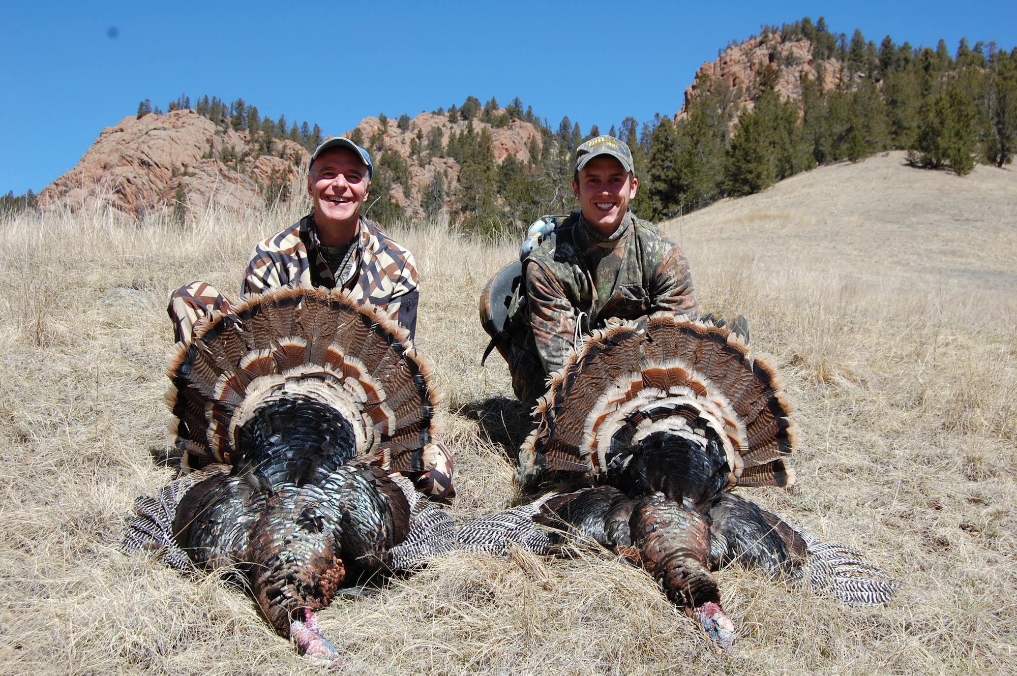 Two hunters with their spring toms below the red rocks at Elk Glade