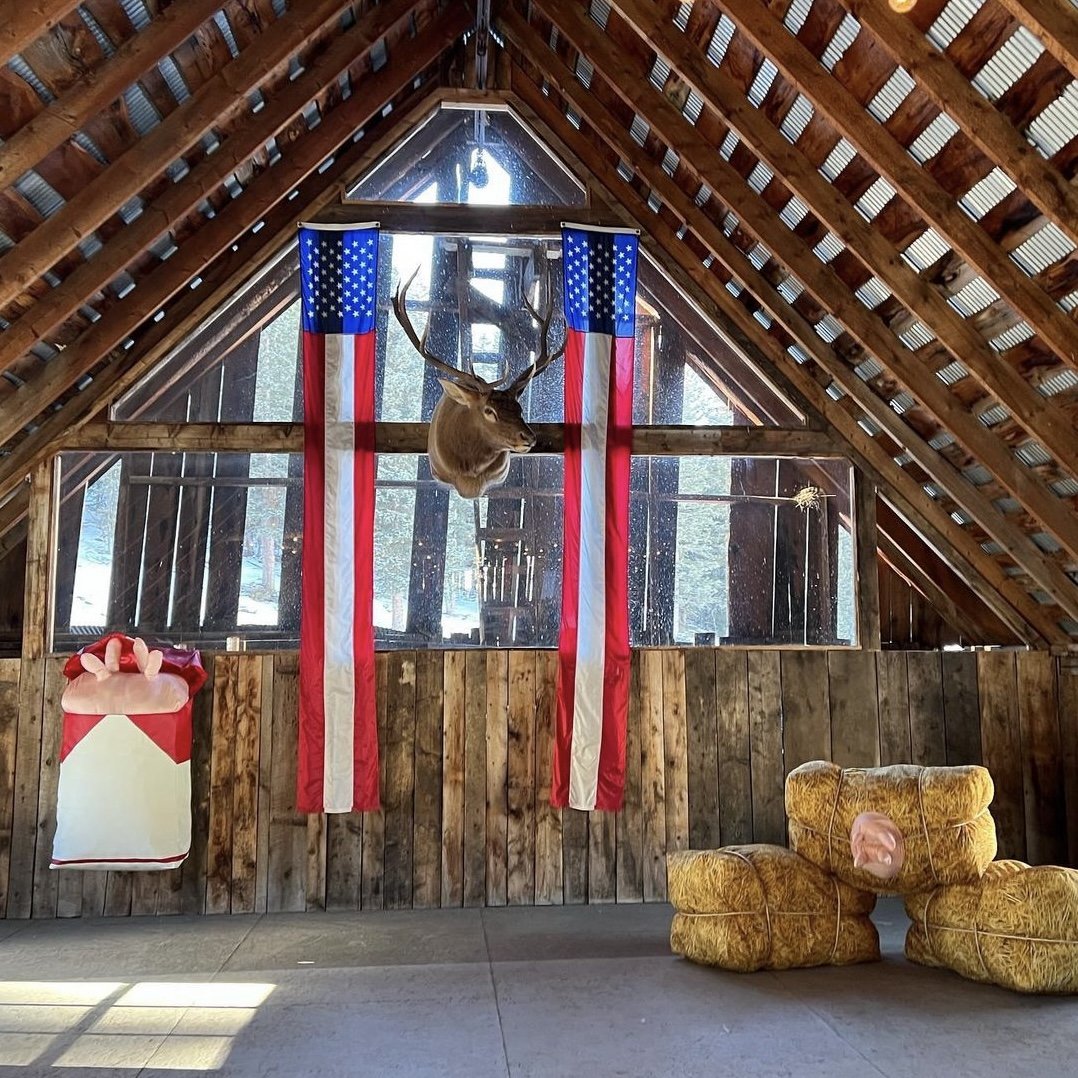Bull elk antlers and flags hung in the Elk Glade barn